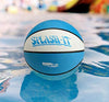 Light blue and white Splash-It pool basketball floating on pool water with a colorful background – Dunnrite waterproof basketball for swimming pools