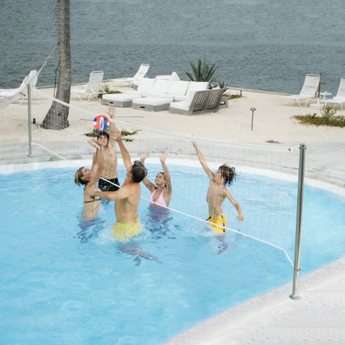 Family playing water volleyball in pool using Dunn-Rite deck-mounted net system