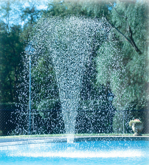 High arching pool fountain spray creating a refreshing vertical fan of water for pool cooling and aesthetics