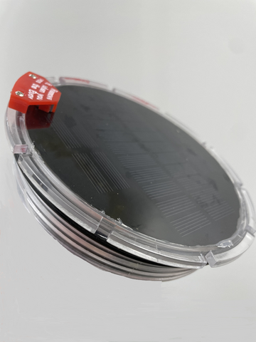 Solar-powered buoy light engine with clear housing and integrated LED panel for automatic nighttime illumination