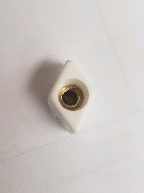 White plastic threaded insert with brass core – diamond shape mounting block for furniture or panel assembly