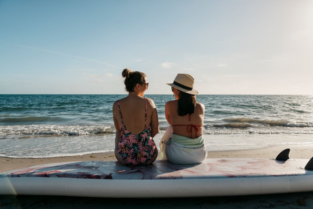 floral inflatable paddleboard - women looking at ocean