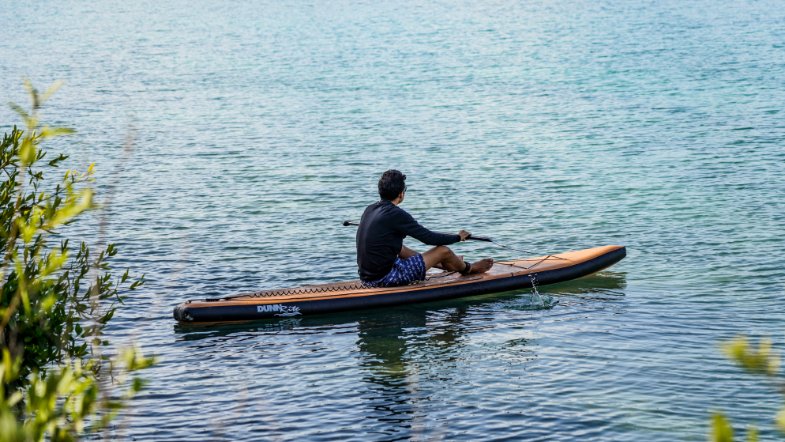 natural wood inflatable paddleboard -sitting in reflection